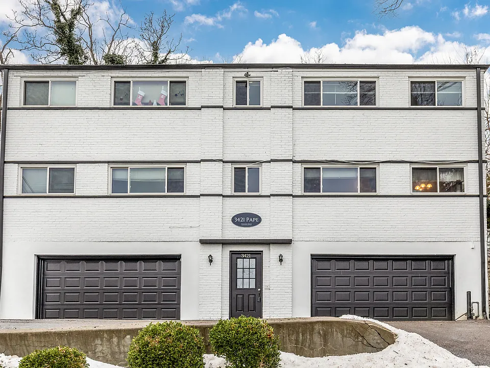 White brick Columbia Ridge apartment building at 3421 Pape Avenue in Cincinnati, with garage parking on the ground level