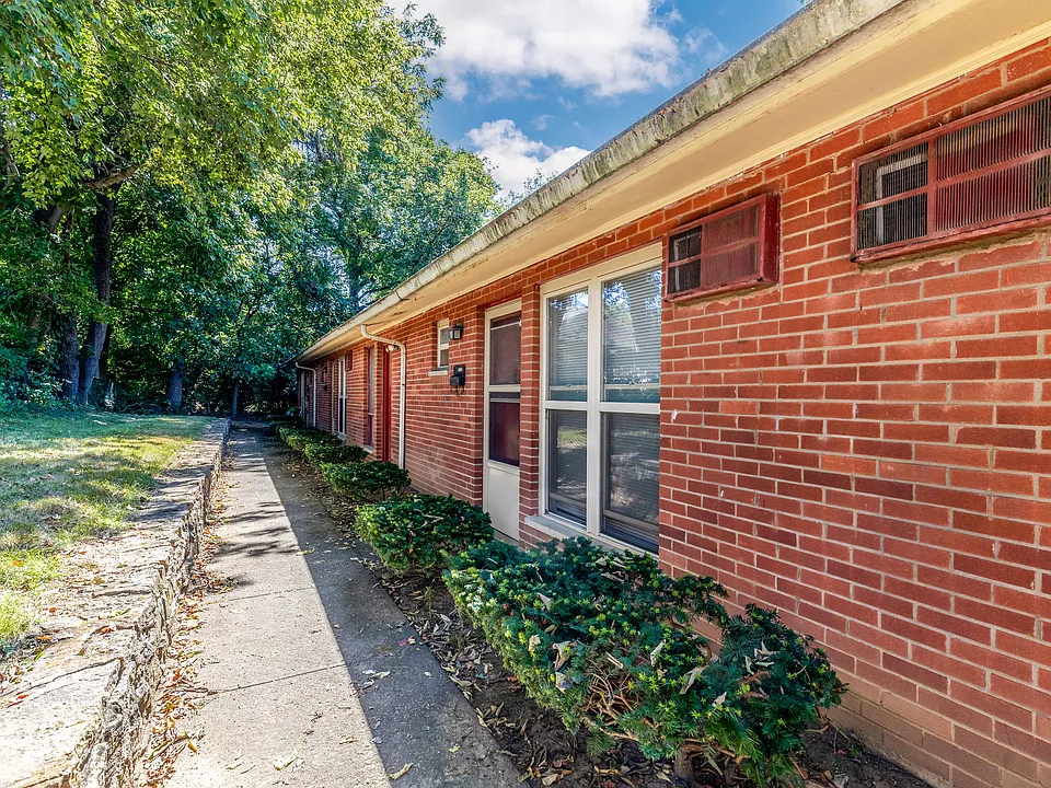 Red brick Columbia Ridge apartment building at 5630 Macey Avenue in Cincinnati, with a walkway along landscaped entries